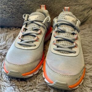 Under Armour Women's Classic Charged Assert 8.5 Gray with Orange accents.